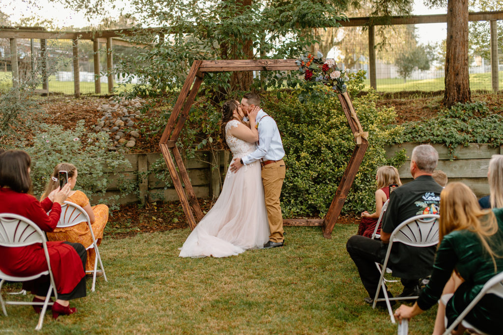 Sydney Jai Photography - wedding ceremony, bride and groom first kiss