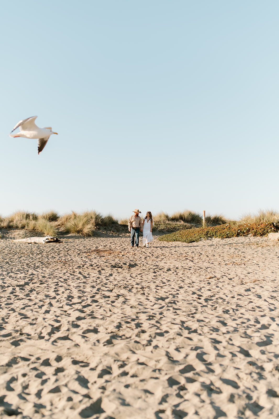 Sydney Jai Photography - western beach elopement, bride and groom walking on beach